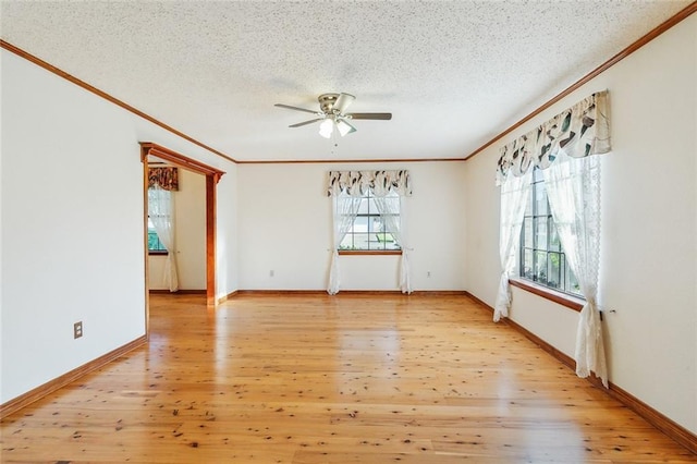 106 Somerset Rd, La Place, LA 70068 - empty room featuring crown molding, light wood-style floors, a textured ceiling, a ceiling fan, and baseboards