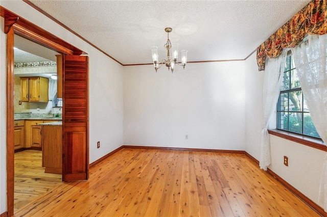106 Somerset Rd, La Place, LA 70068 - unfurnished dining area featuring light wood-type flooring, an inviting chandelier, ornamental molding, and a textured ceiling