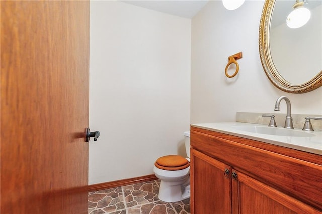 106 Somerset Rd, La Place, LA 70068 - half bathroom with toilet, vanity, and baseboards