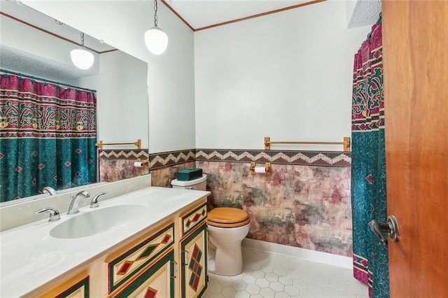 106 Somerset Rd, La Place, LA 70068 - bathroom featuring vanity, ornamental molding, tile patterned floors, toilet, and a wainscoted wall