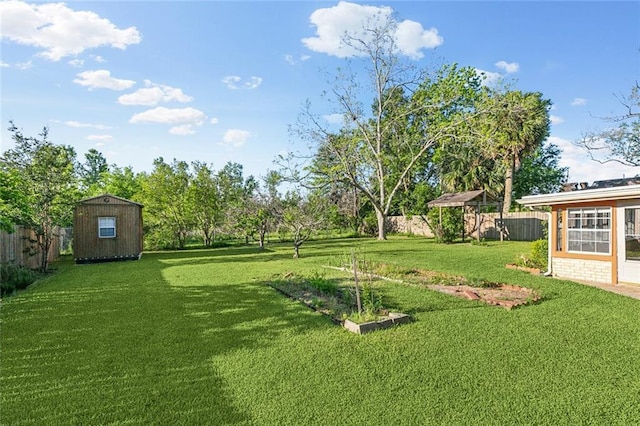 106 Somerset Rd, La Place, LA 70068 - view of yard with an outbuilding, a fenced backyard, and a storage unit