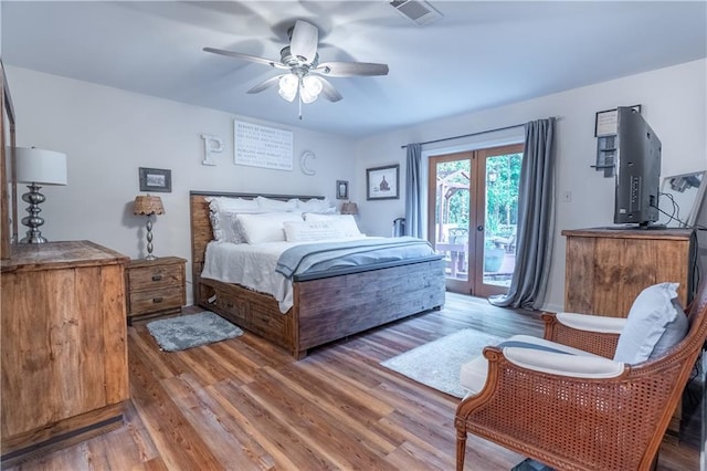 bedroom featuring light wood-type flooring, a ceiling fan, visible vents, access to exterior, and french doors