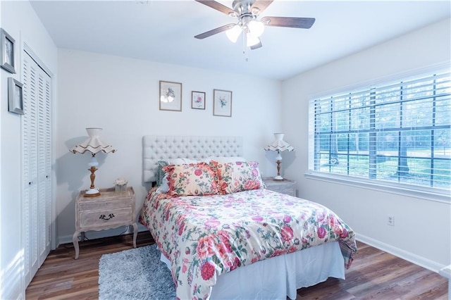 bedroom with a closet, baseboards, a ceiling fan, and wood finished floors