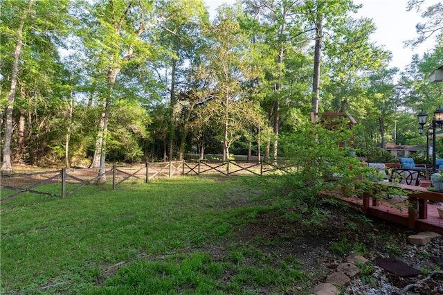 view of yard with fence and a deck