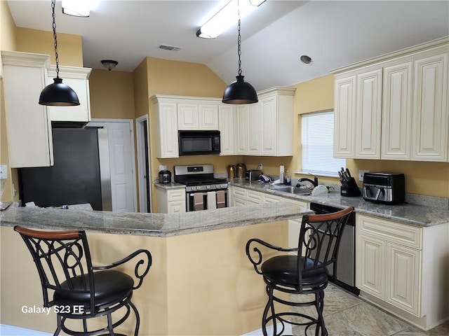 637 Foxwood Ln, La Place, LA 70068 - kitchen with stainless steel appliances, visible vents, a kitchen bar, and a sink
