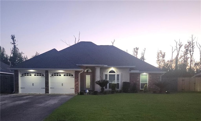 637 Foxwood Ln, La Place, LA 70068 - single story home featuring a garage, a front yard, brick siding, and driveway