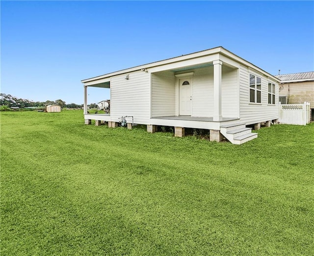 2605 Privateer Blvd, Barataria, LA 70036 - rear view of house featuring a lawn