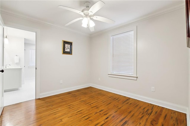2605 Privateer Blvd, Barataria, LA 70036 - empty room featuring wood finished floors, ornamental molding, a ceiling fan, and baseboards