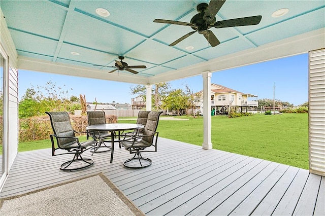 2605 Privateer Blvd, Barataria, LA 70036 - wooden deck featuring ceiling fan, outdoor dining area, and a lawn