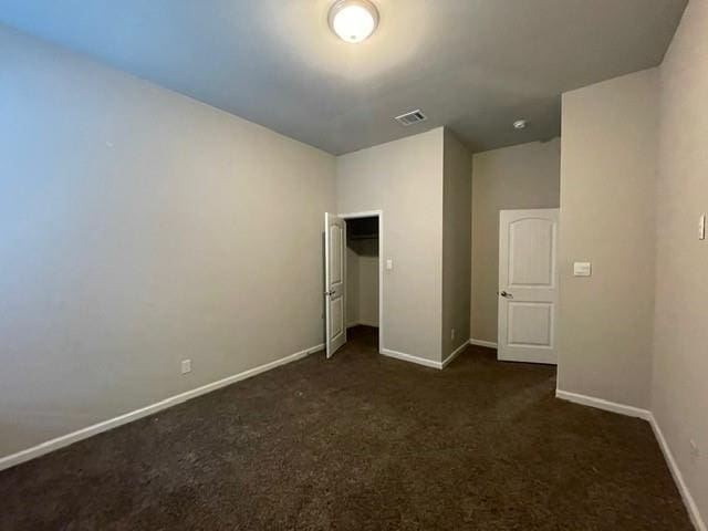 unfurnished bedroom with baseboards, visible vents, a closet, and carpet