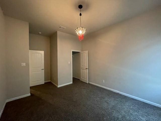 empty room featuring visible vents, carpet flooring, and baseboards