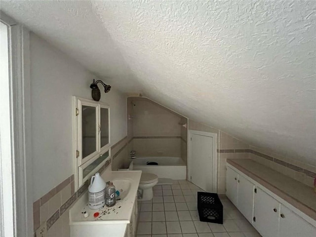 721 Central Ave, Reserve, LA 70084 - bathroom featuring a textured ceiling, vanity, tile patterned flooring, vaulted ceiling, and toilet