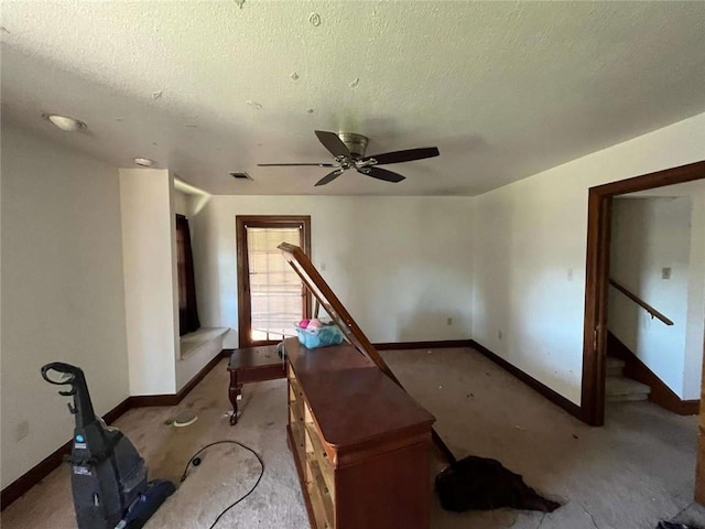 721 Central Ave, Reserve, LA 70084 - interior space featuring light carpet, baseboards, a ceiling fan, and a textured ceiling