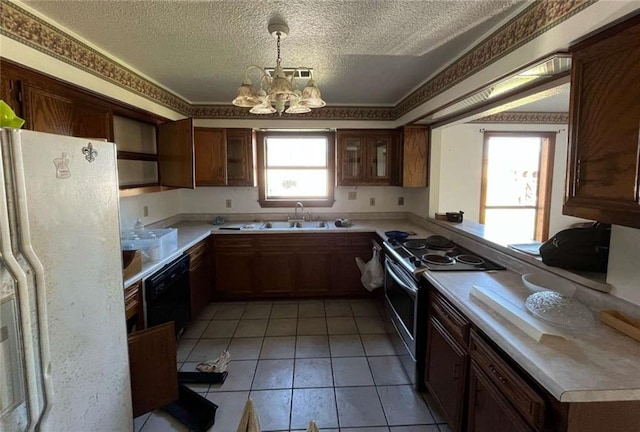 721 Central Ave, Reserve, LA 70084 - kitchen with an inviting chandelier, a textured ceiling, freestanding refrigerator, stainless steel range with electric cooktop, and a sink