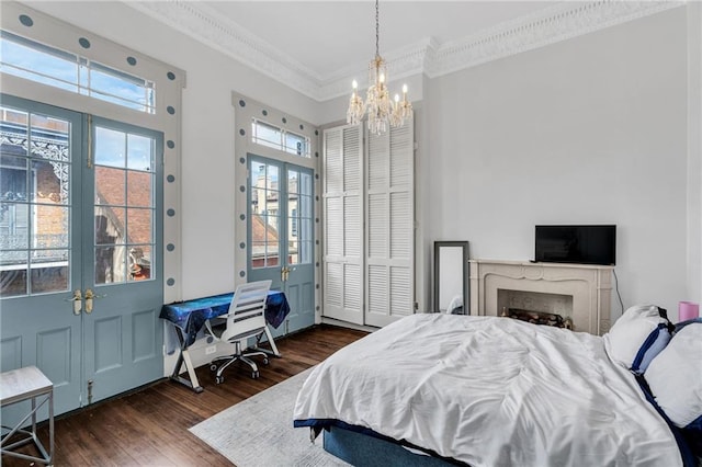 818 Bourbon St Unit 2A, New Orleans, LA 70116 - bedroom with crown molding, dark wood finished floors, and a chandelier