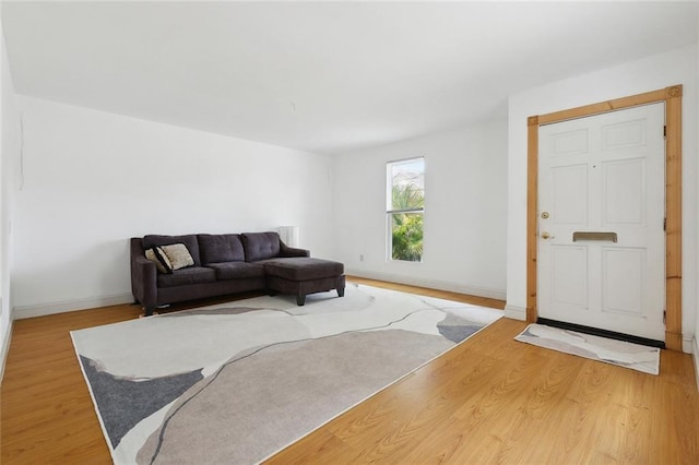living room with light wood-style flooring and baseboards
