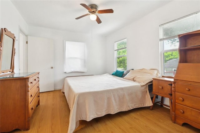 bedroom featuring light wood-style flooring and ceiling fan