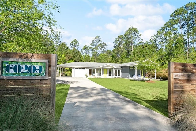 60209 Pine Dr, Lacombe, LA 70445 - view of front of house featuring an attached garage, concrete driveway, and a front yard