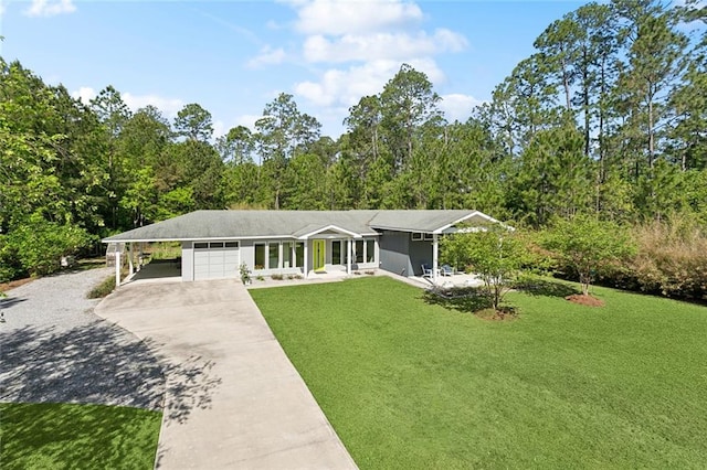 60209 Pine Dr, Lacombe, LA 70445 - view of front of house featuring a front lawn, an attached garage, an attached carport, and concrete driveway