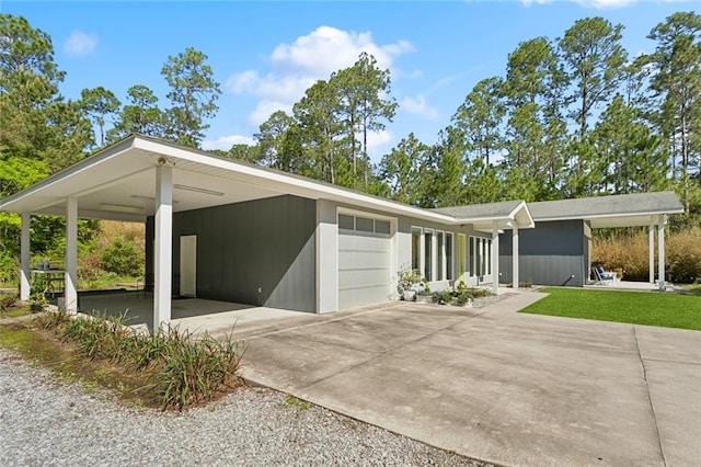 60209 Pine Dr, Lacombe, LA 70445 - view of front of property with concrete driveway, a front yard, and an attached garage