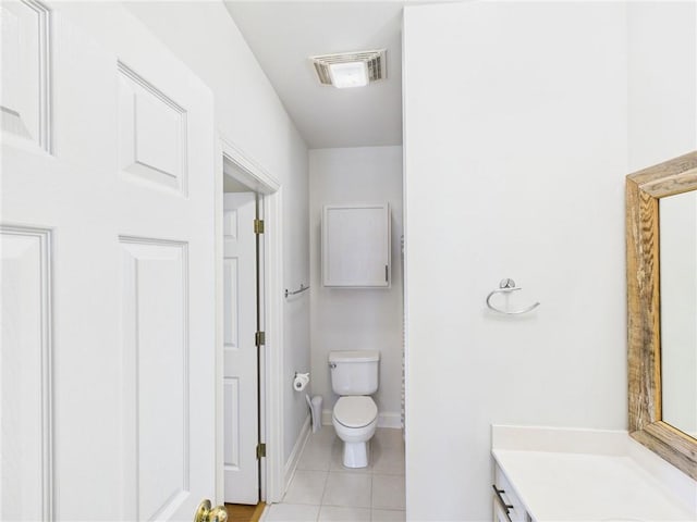bathroom with vanity, tile patterned flooring, visible vents, toilet, and baseboards