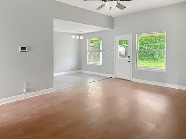 interior space with light wood-type flooring, baseboards, and a ceiling fan