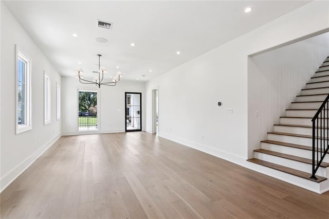6371 Louis Xiv St, New Orleans, LA 70124 - unfurnished living room featuring a chandelier, light wood-style floors, stairs, and recessed lighting