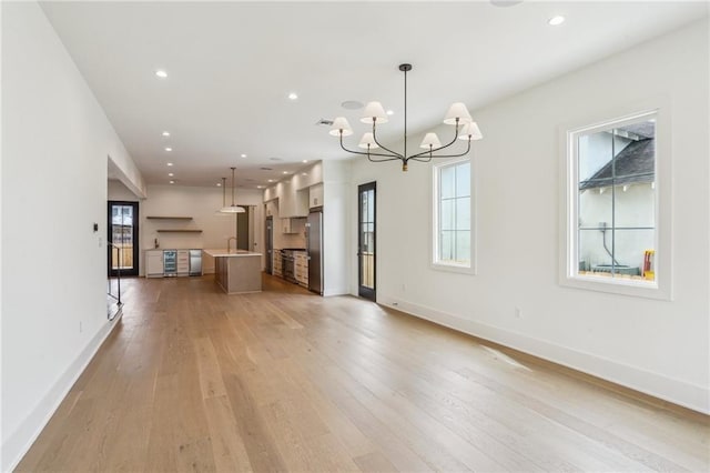 6371 Louis Xiv St, New Orleans, LA 70124 - unfurnished living room featuring a chandelier, light wood-style floors, and recessed lighting