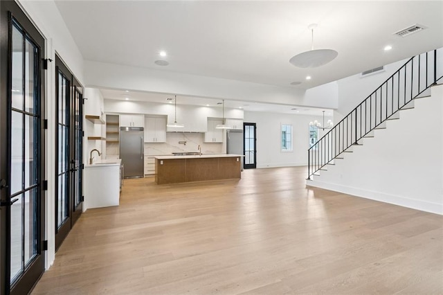 6371 Louis Xiv St, New Orleans, LA 70124 - kitchen with built in refrigerator, light wood-style flooring, light countertops, open floor plan, and recessed lighting