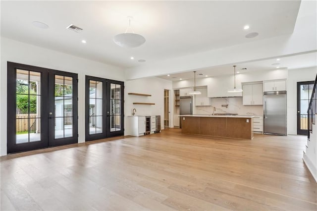 6371 Louis Xiv St, New Orleans, LA 70124 - kitchen with built in fridge, french doors, light wood finished floors, open floor plan, and recessed lighting