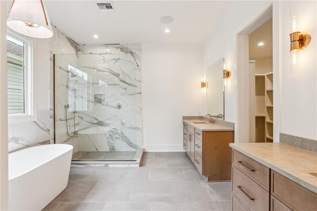 6371 Louis Xiv St, New Orleans, LA 70124 - bathroom with a marble finish shower, vanity, a freestanding bath, and recessed lighting