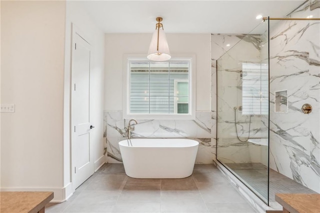 6371 Louis Xiv St, New Orleans, LA 70124 - bathroom featuring a marble finish shower, a freestanding tub, and tile walls