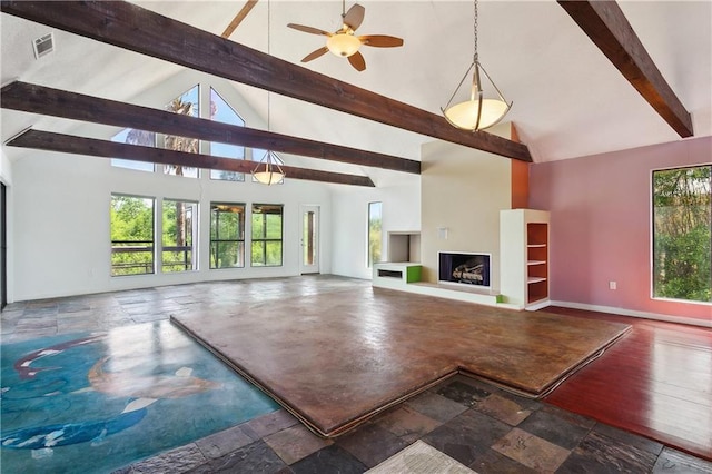 unfurnished living room featuring high vaulted ceiling, beamed ceiling, ceiling fan, a fireplace with raised hearth, and visible vents