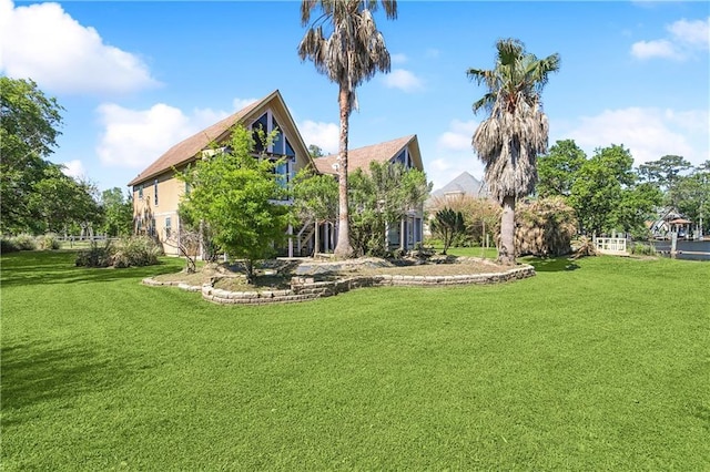 rear view of property with a yard