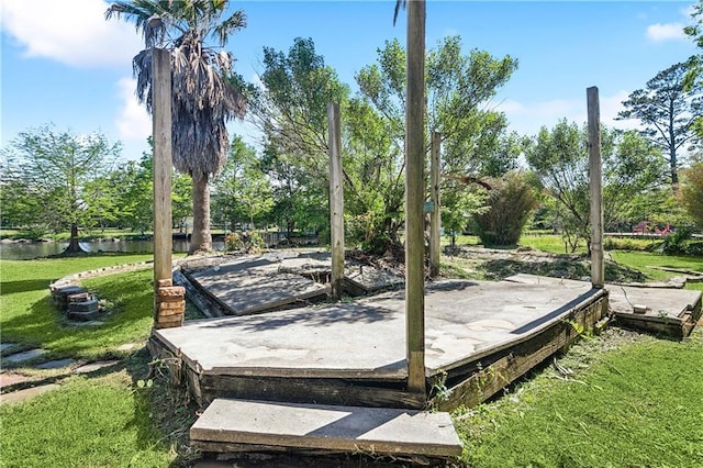 wooden deck with a yard and a water view