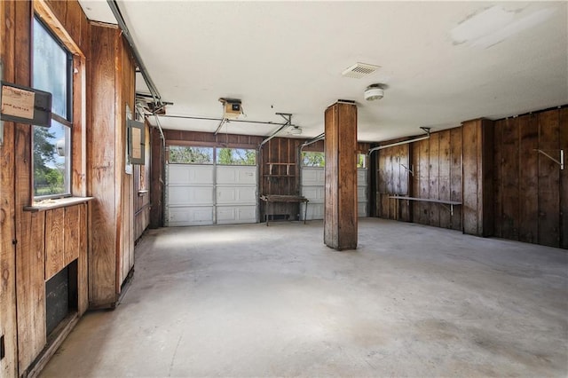 garage featuring wood walls and visible vents