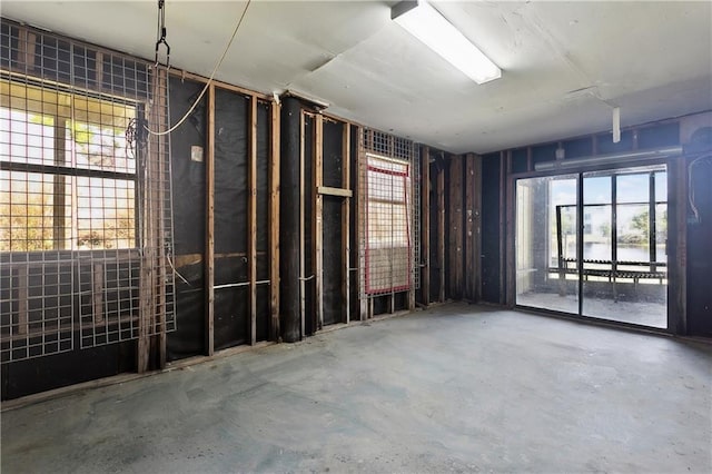 misc room featuring unfinished concrete floors and plenty of natural light