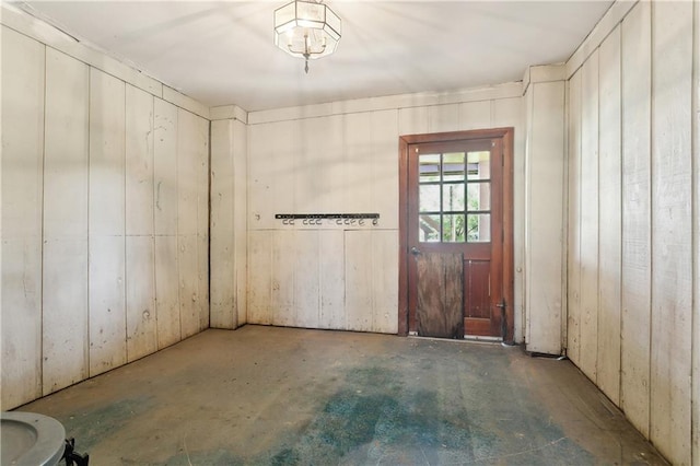 empty room with unfinished concrete flooring