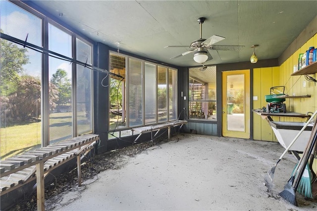 unfurnished sunroom featuring a wealth of natural light and ceiling fan