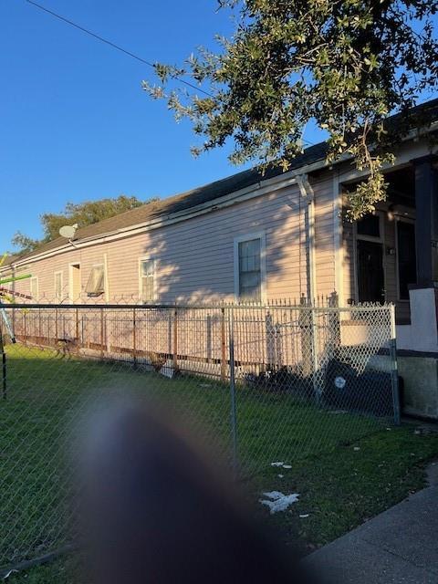 275755 Toulouse St, New Orleans, LA 70119 - view of home's exterior with fence and a lawn