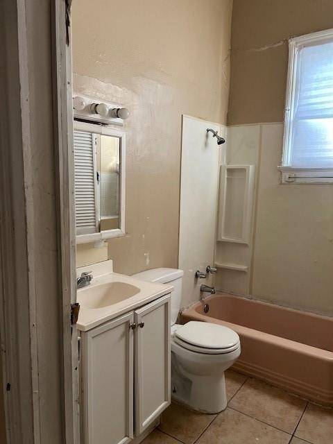 275755 Toulouse St, New Orleans, LA 70119 - bathroom with toilet, tile patterned floors, vanity, and shower / bathtub combination