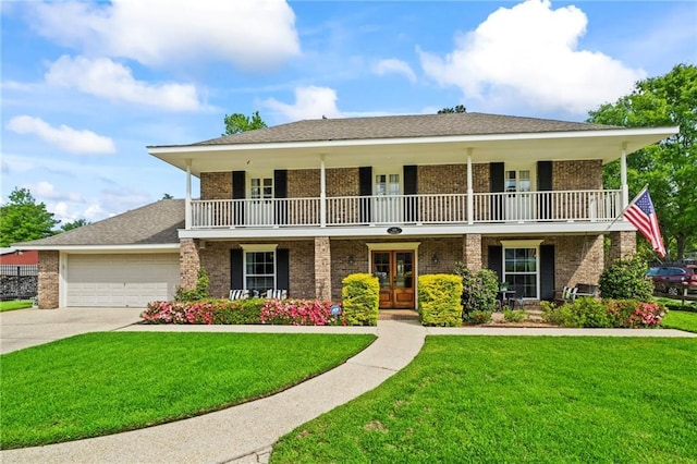 616 Marilyn Dr, Mandeville, LA 70448 - view of front of home with an attached garage, a balcony, brick siding, french doors, and a front lawn