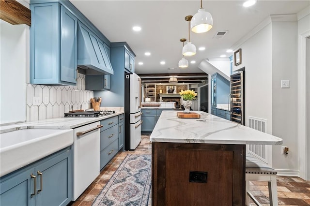 616 Marilyn Dr, Mandeville, LA 70448 - kitchen featuring custom exhaust hood, a center island, white appliances, recessed lighting, and blue cabinetry