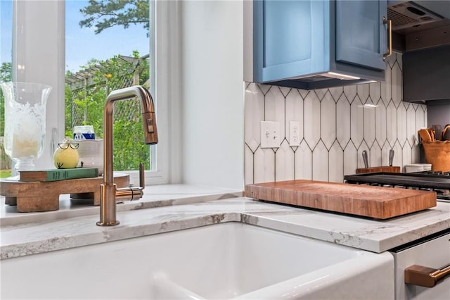 616 Marilyn Dr, Mandeville, LA 70448 - room details featuring decorative backsplash, light stone counters, and ventilation hood