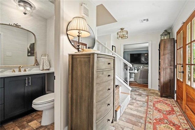 616 Marilyn Dr, Mandeville, LA 70448 - bathroom with a chandelier, vanity, visible vents, and toilet