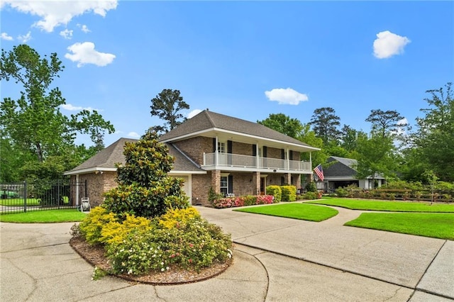 616 Marilyn Dr, Mandeville, LA 70448 - view of front of property with brick siding, a front yard, driveway, and a balcony