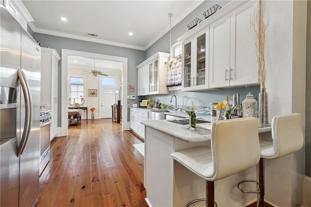 727 N Salcedo St, New Orleans, LA 70119 - kitchen with visible vents, glass insert cabinets, white cabinetry, stainless steel appliances, and dark wood-type flooring