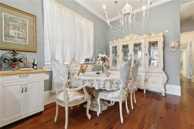 727 N Salcedo St, New Orleans, LA 70119 - dining room featuring dark wood-type flooring, ornamental molding, baseboards, and an inviting chandelier