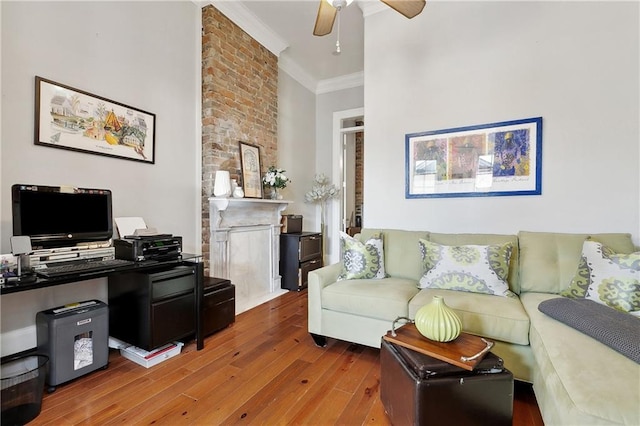 727 N Salcedo St, New Orleans, LA 70119 - living area featuring a large fireplace, ornamental molding, ceiling fan, and wood finished floors