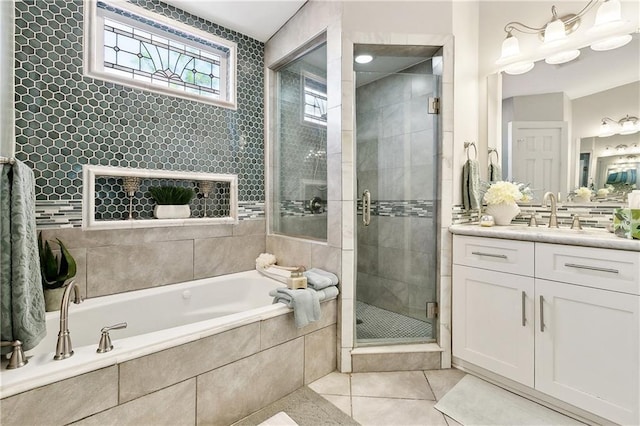727 N Salcedo St, New Orleans, LA 70119 - full bathroom with a stall shower, a garden tub, vanity, and tile patterned floors
